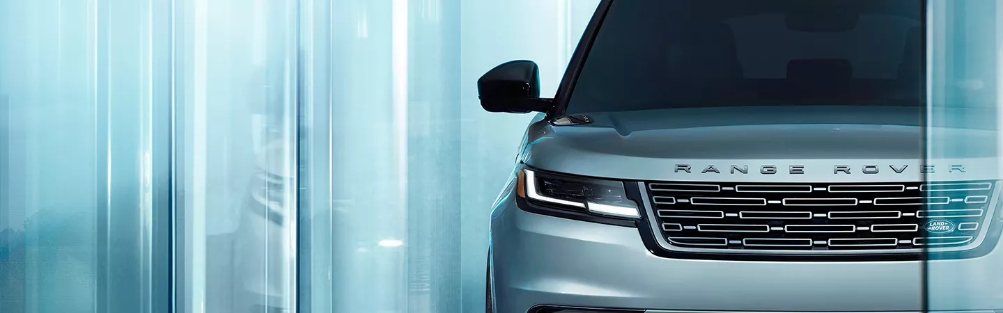 Front grill view of a 2026 Range Rover Velar parked in a showroom