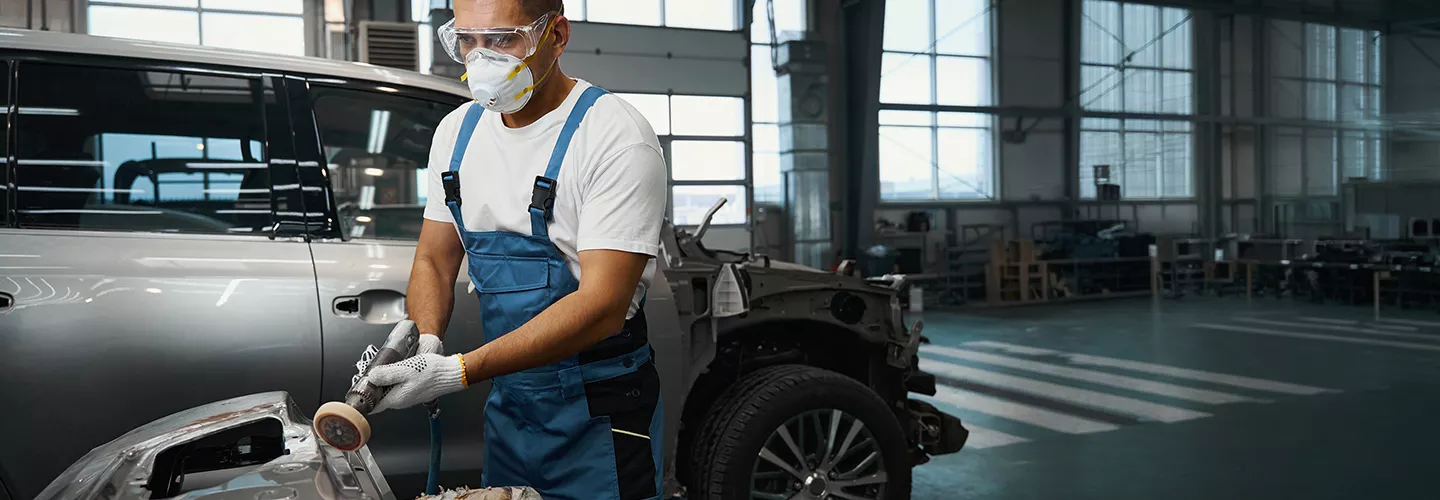 tech working inside body shop