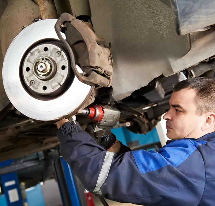Technician servicing a vehicle