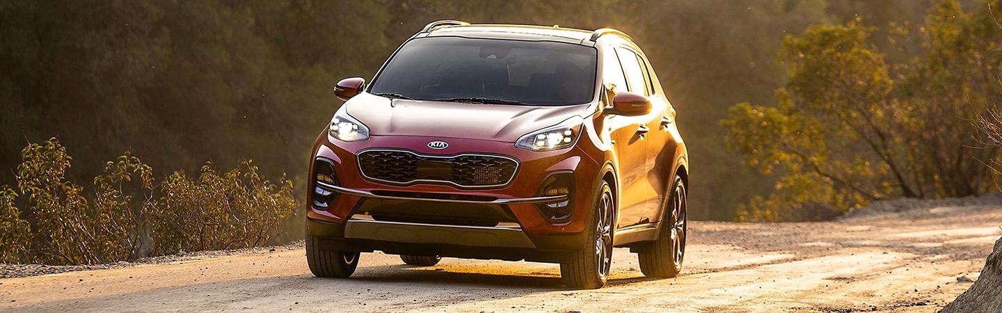 Red 2022 Kia Sportage in motion front view
