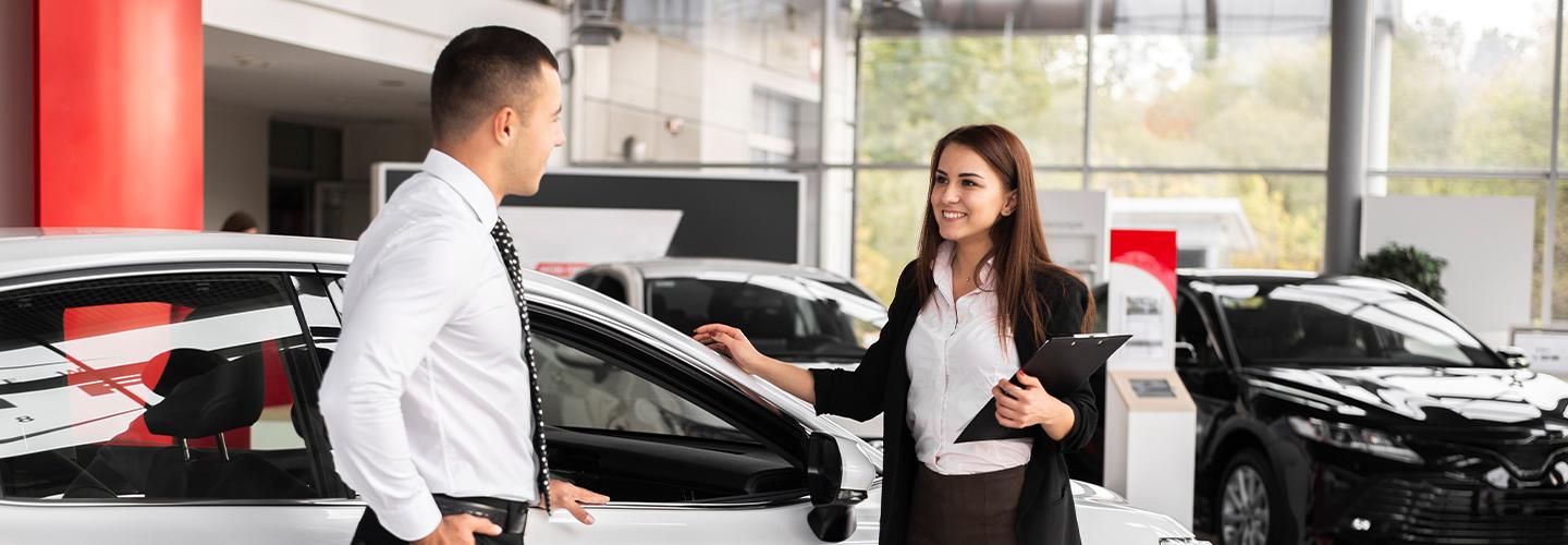 man and woman in dealership