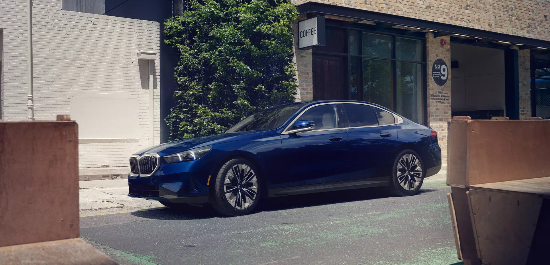 profile blue the new BMW 530i sedan parked on street