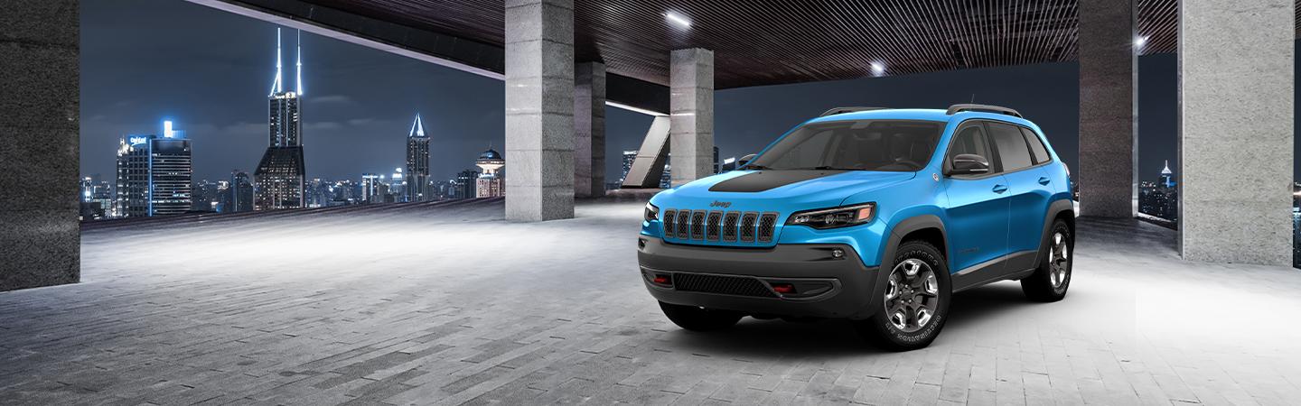 2021 Jeep Cherokee parked with city in the background