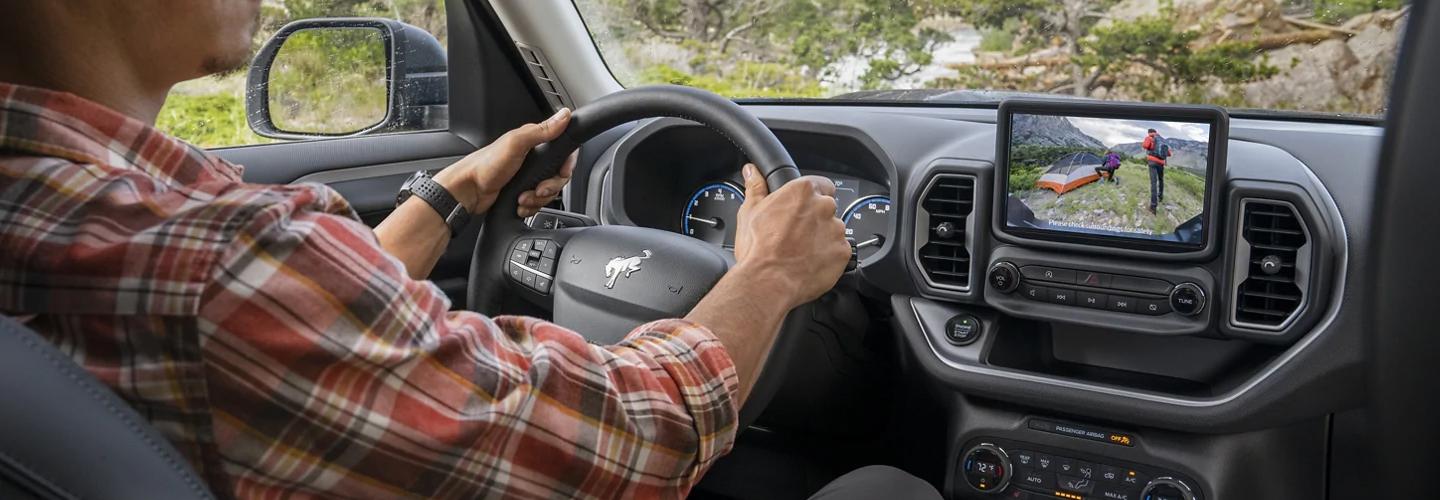 Interior of 2021 Ford Bronco Sport with person driving