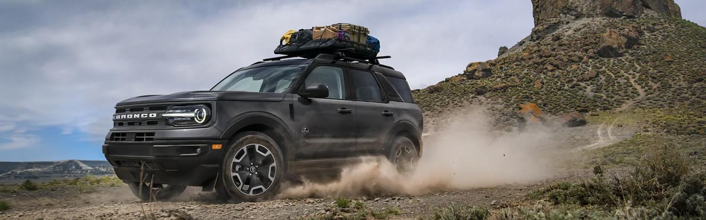 Black 2021 Ford Bronco Sport driving through desert ridge