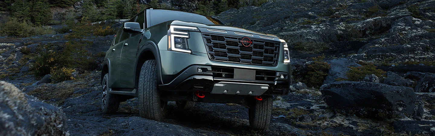 Front view of a parked 2026 Nissan Armada on some rocks