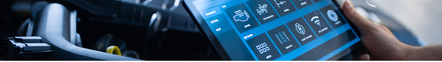 tech with tablet assessing car