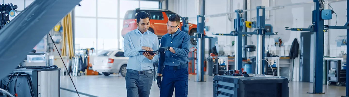 a car mechanic discussing car repair with another person