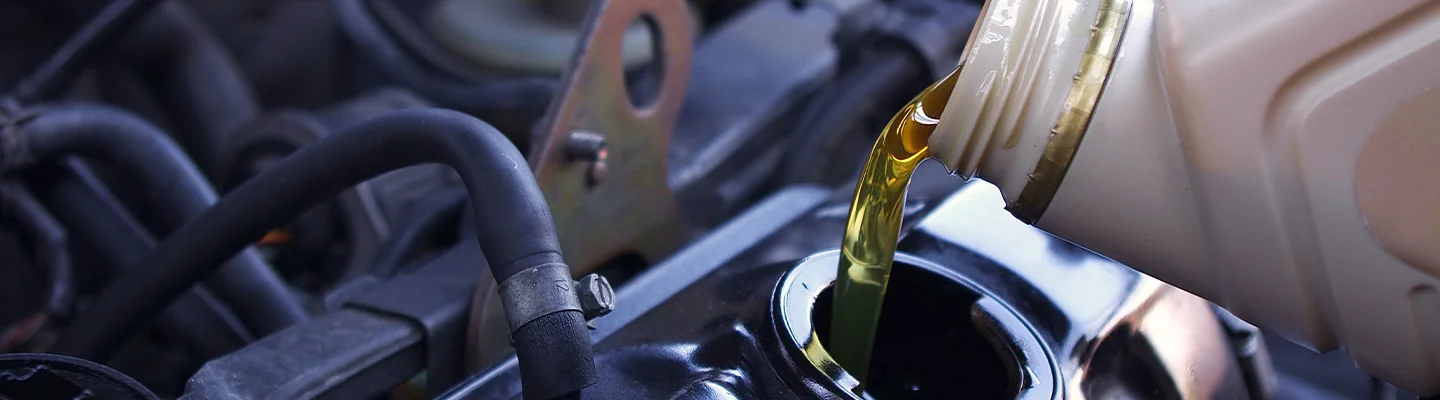 Engine oil being poured into a car engine