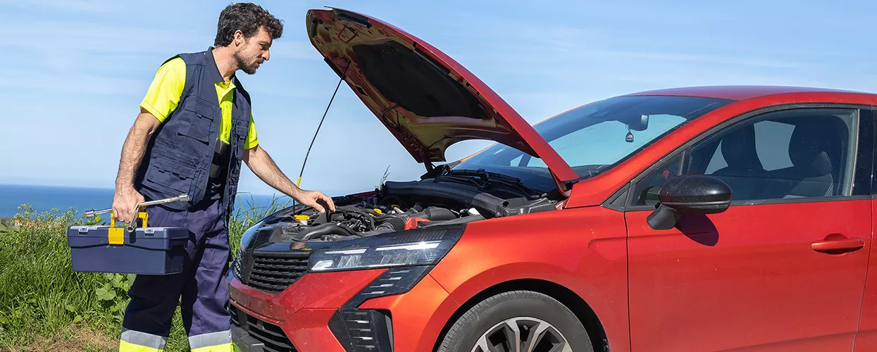 Ford mobile service technician working on a vehicle at a customer's home