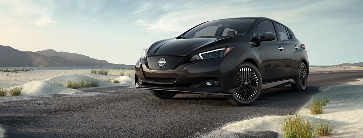 a black 2025 Nissan Leaf parked at the beach