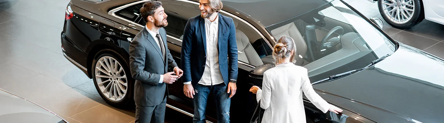 BMW sales person talking to customers about buying CPO car