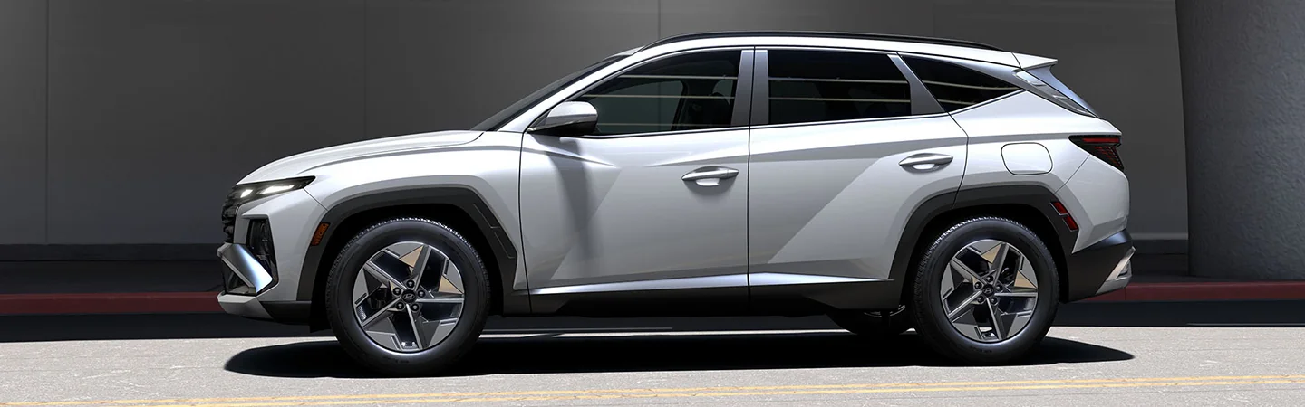 drive side view of a white 2025 Hyundai Tucson