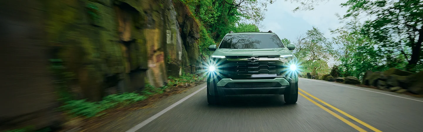 Front view of a 2026 Chevrolet Equinox driving on a street