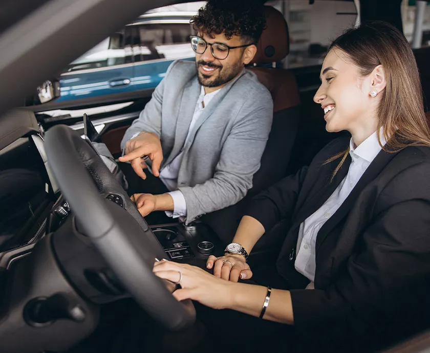 Sales person showing a custoemr the inside of a 2027 Jeep Grand Cherokee
