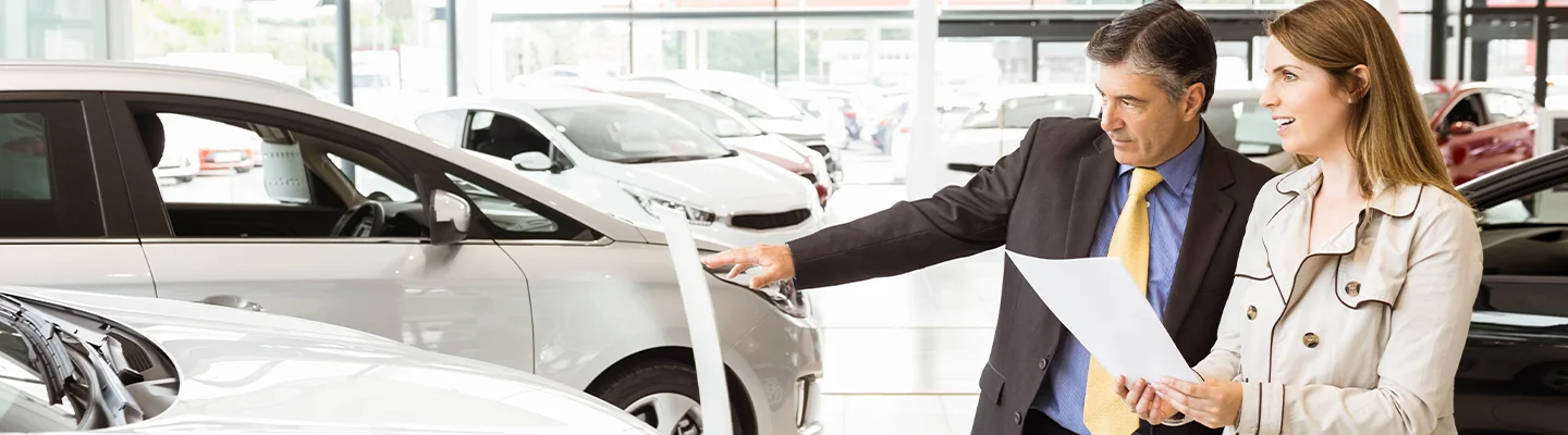 Car salesperson showing a vehicle to a customer at CDJR of Leesburg