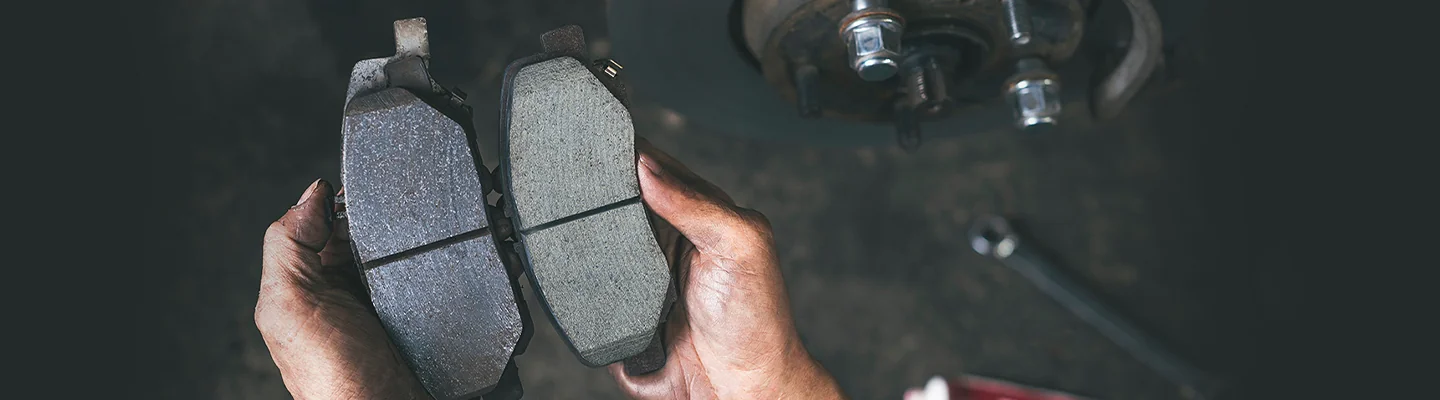 Brake pads being looked at by service tech