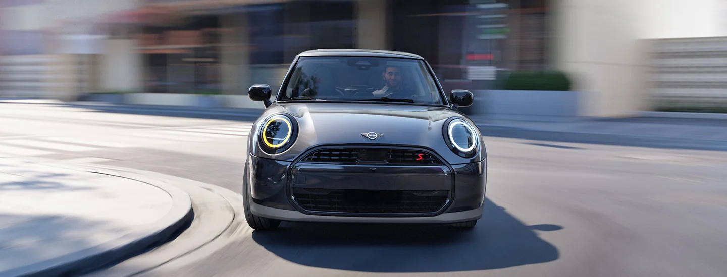 front view of a 2026 MINI Cooper 2-Door rounding a corner