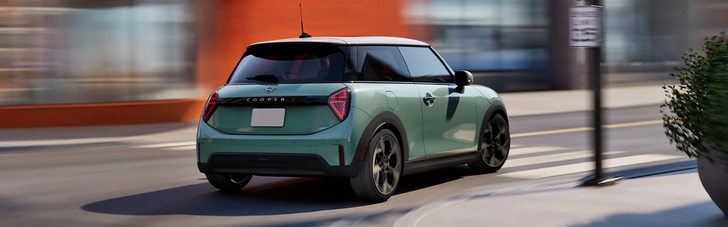 rear view of a 2026 MINI Cooper 2-Door C taking a corner in motion
