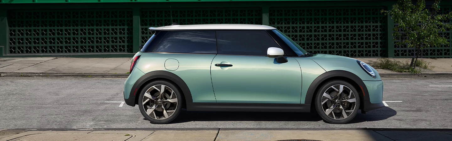 view from passenger side of a light green 2026 MINI Cooper 2-Door C view from passenger side