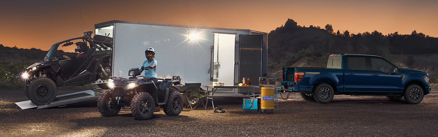 2025 Ford F-150 Raptor® unloading offroad toys from trailer