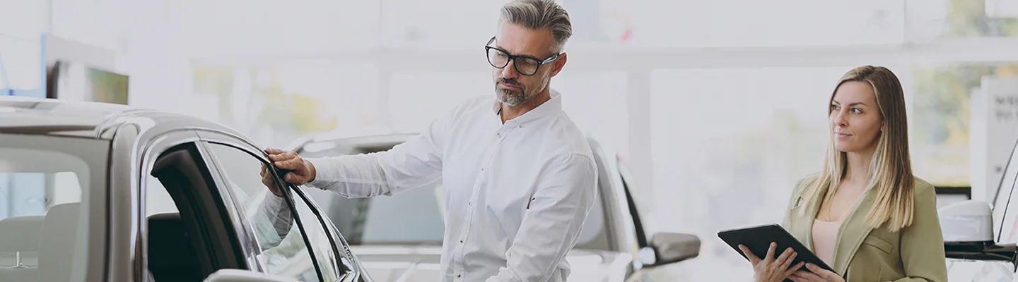 Salesperson showing a vehicle to a customer