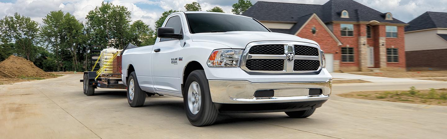 2021 RAM 1500 in motion towing a trailer front view