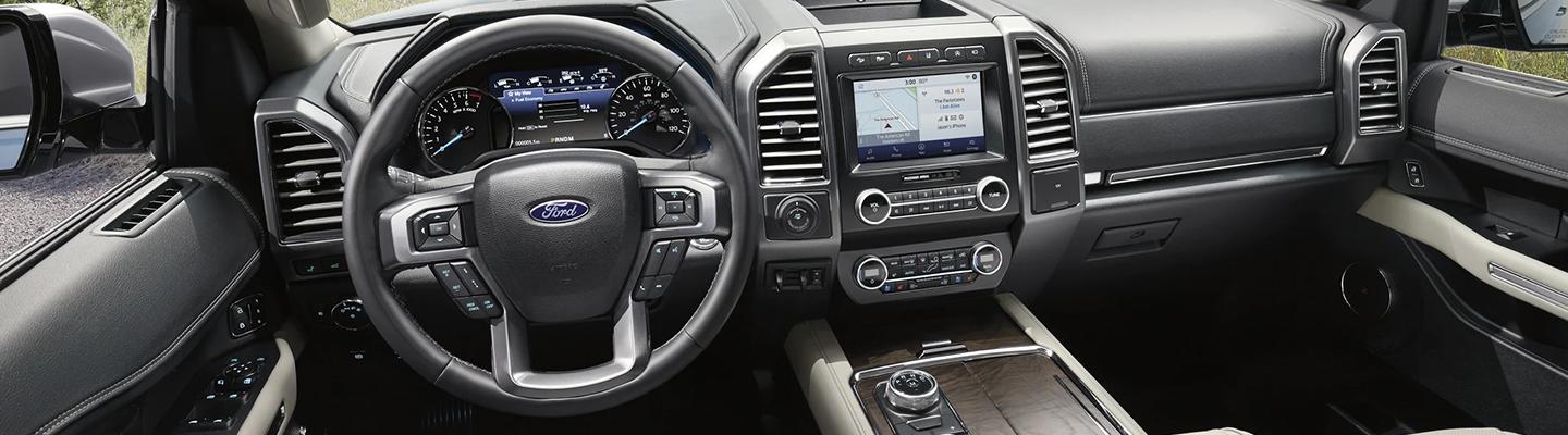 hand pointing at gps screen in car