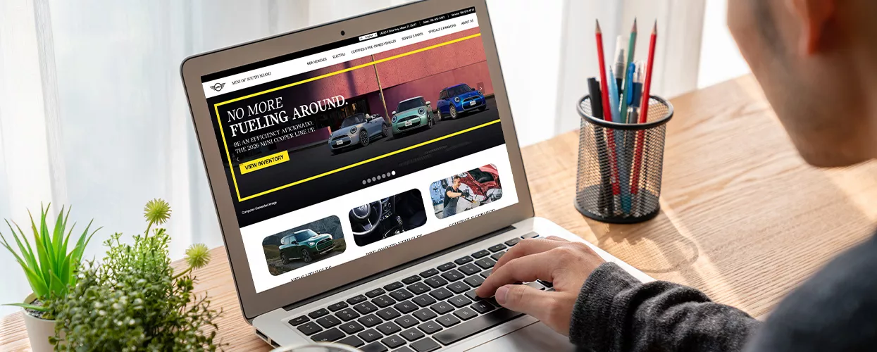 Customer looking at the MINI of South Miami website on their laptop