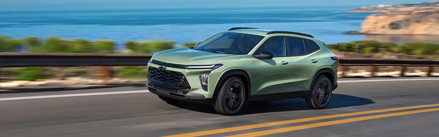 Green 2025 Chevrolet Trax driving down the coast
