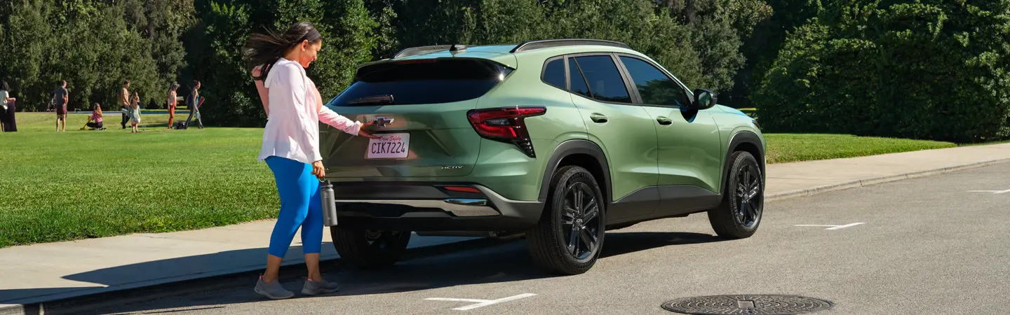 Back view of a parked green 2025 Chevrolet Trax
