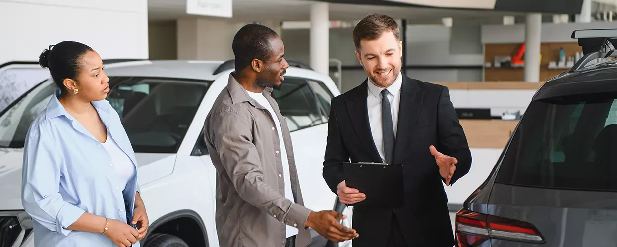 rep and customers in car showroom