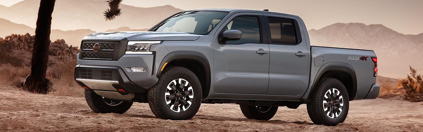 Side view of a parked gray 2022 Nissan Frontier