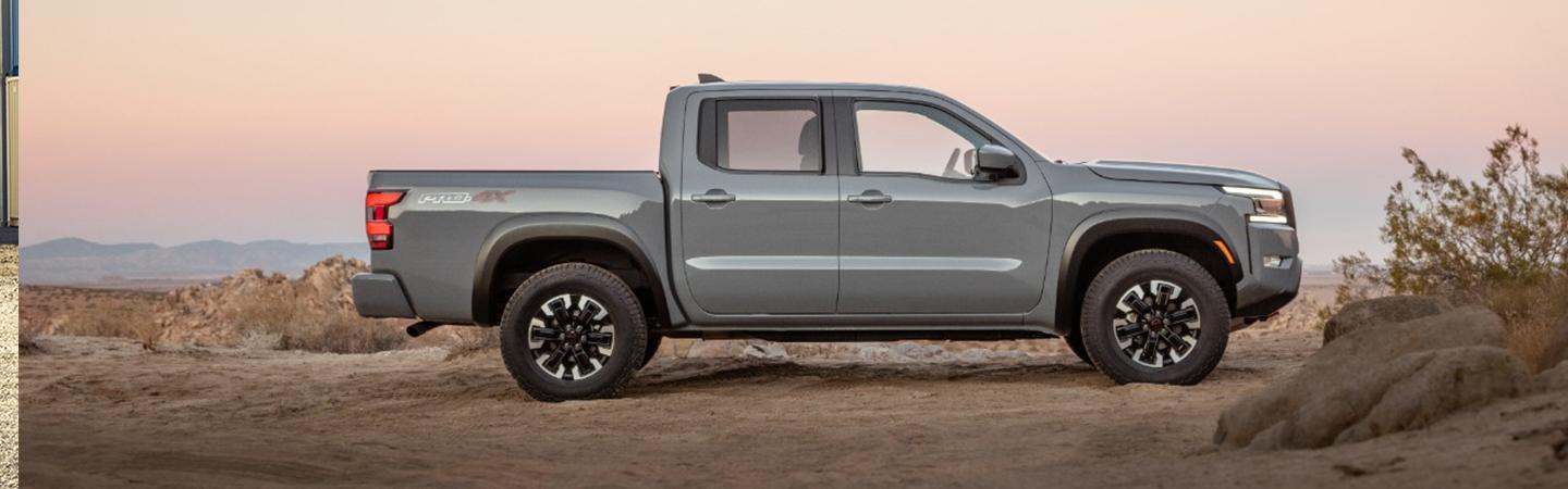 Side view of a parked gray 2022 Nissan Frontier
