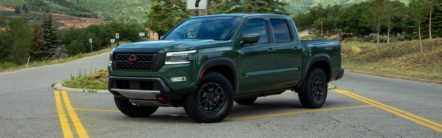Green parked 2022 Nissan Frontier in the road