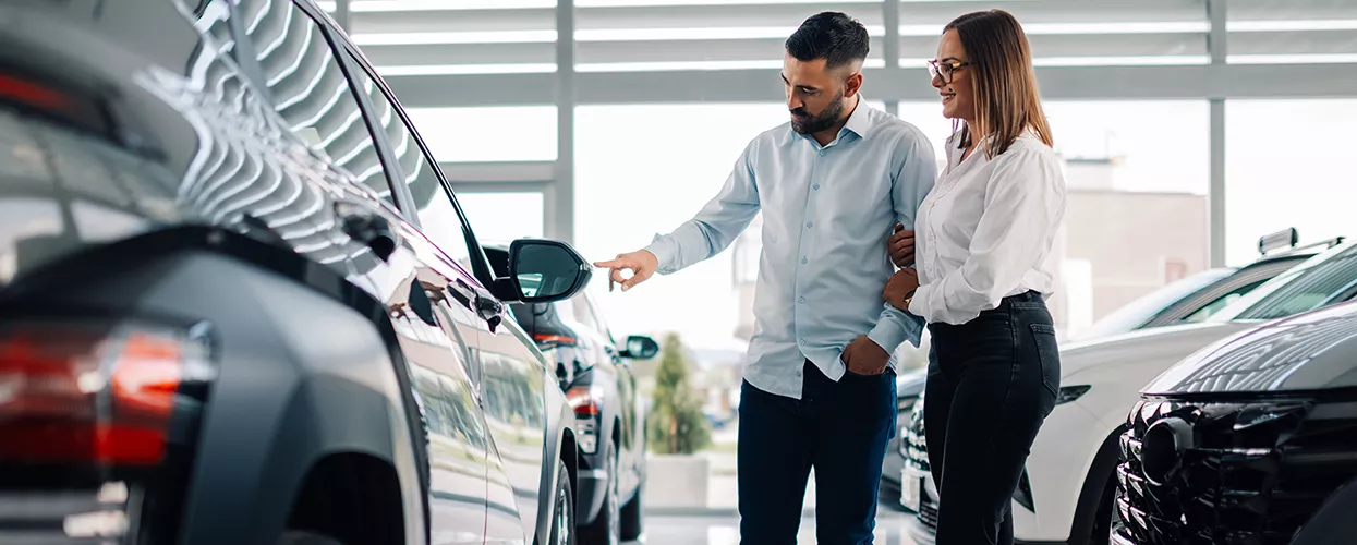 Couple looking at a new car in a dealership