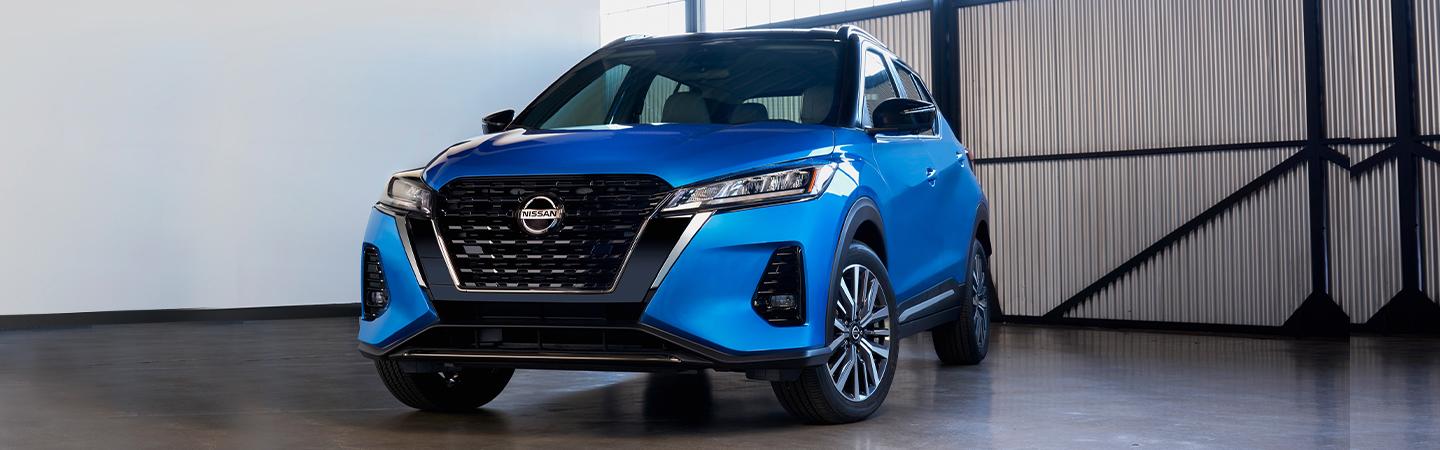 Blue 2021 Nissan Kicks parked in a whearhouse