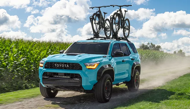 Light blue Toyota 4Runner vehicle image with bikes racked on top from Bill Penney Toyota in Huntsville, AL