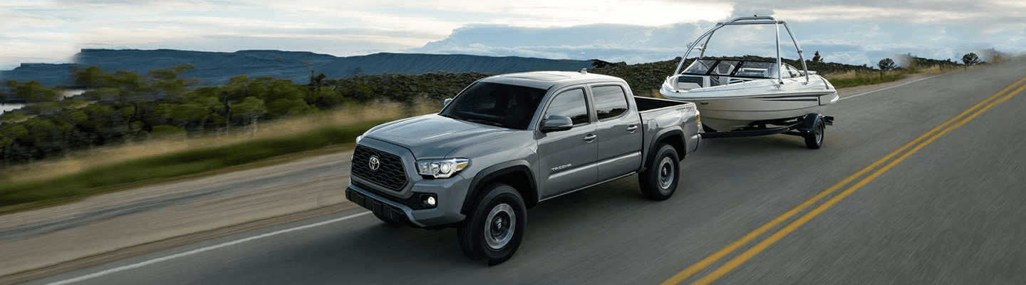 2021 Toyota Tacoma Towing a Boat on Road