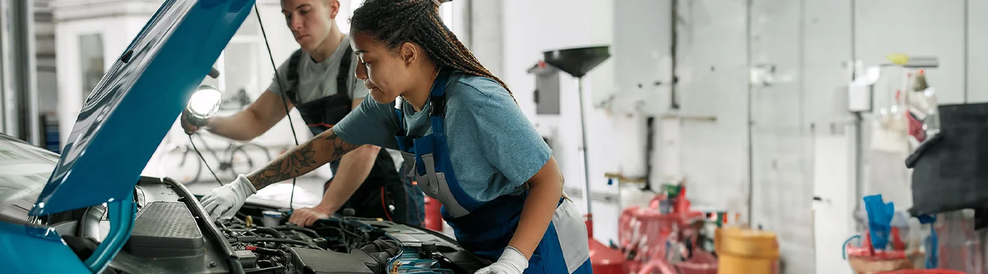 techs working on car engine