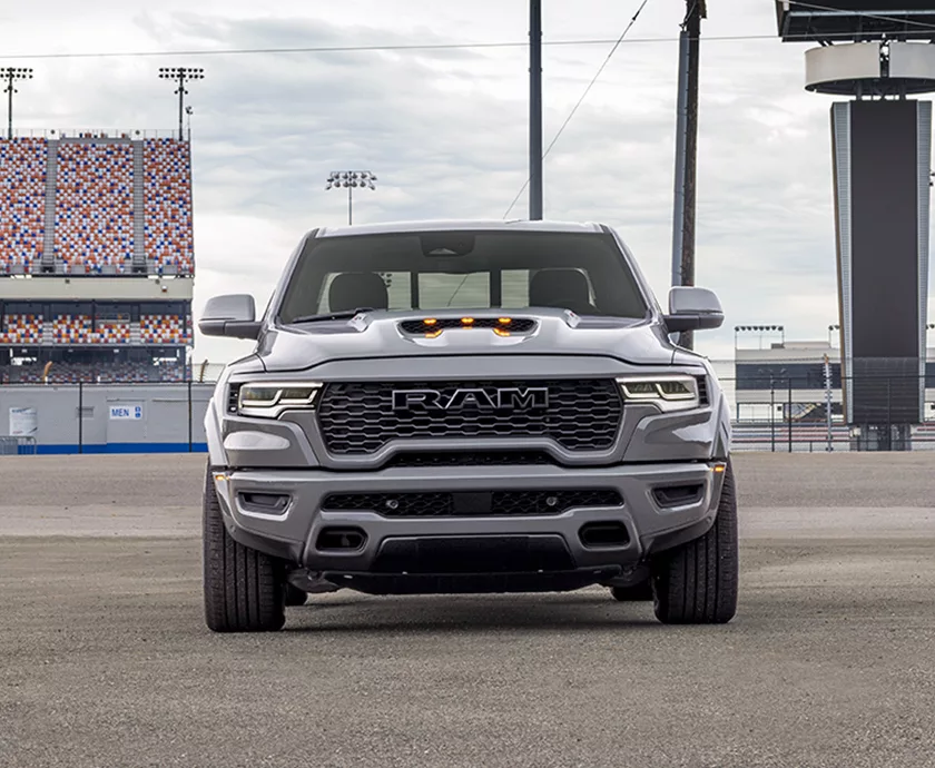 Front view of a gray parked 2027 RAM 1500 at a racetrack