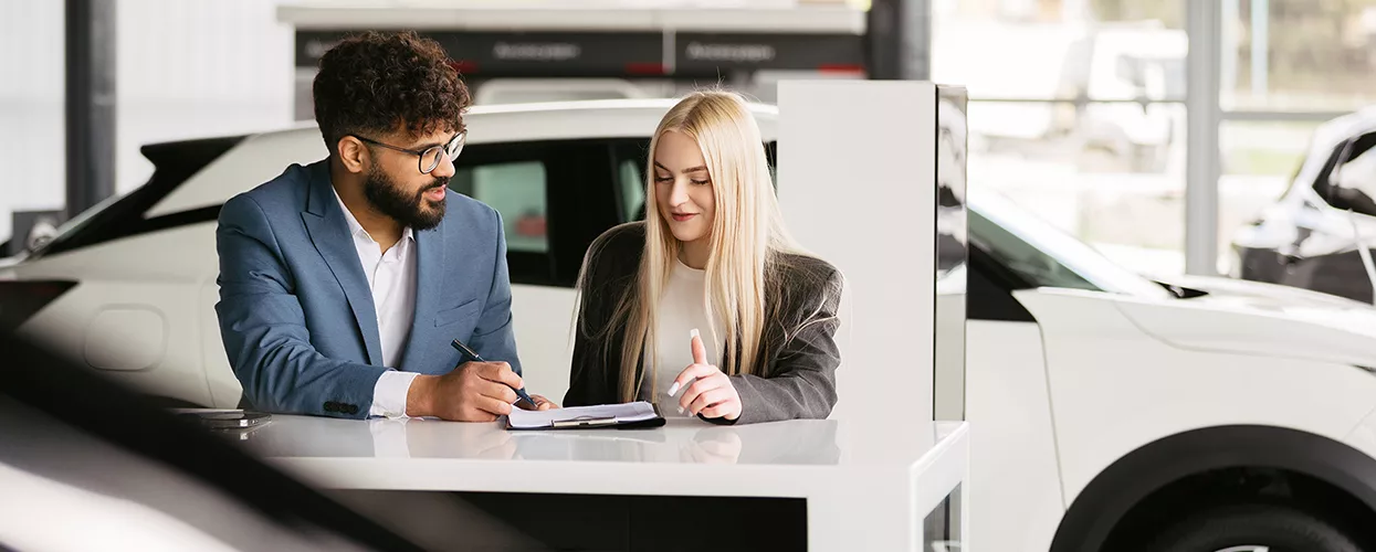 Car salesman talking to a customer about a contract