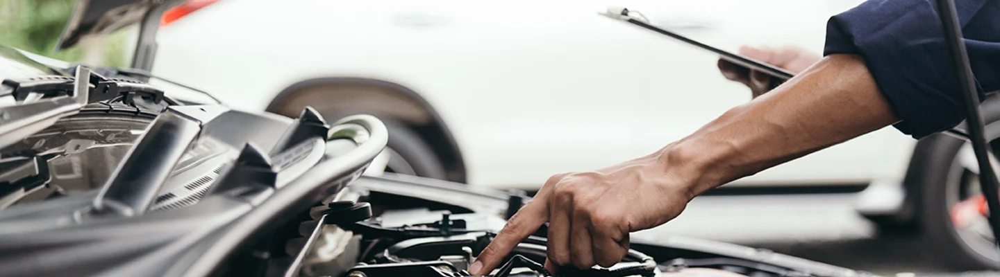auto mecaninc working on car