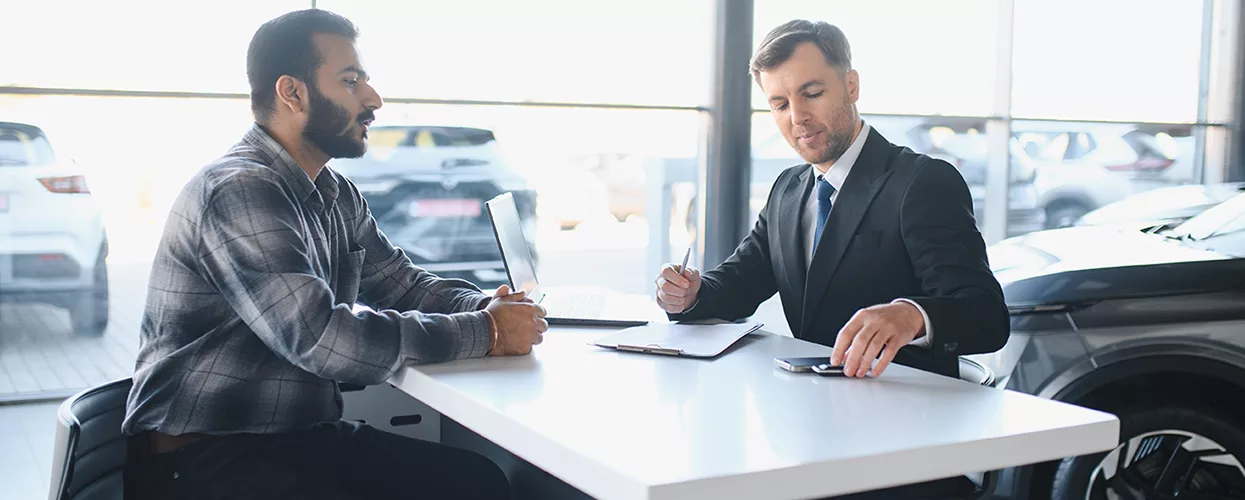 Car salesman talking to a customer about a contract