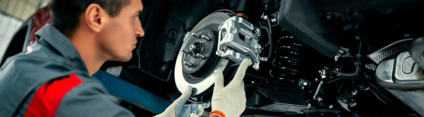 Mechanic servicing a brake caliper