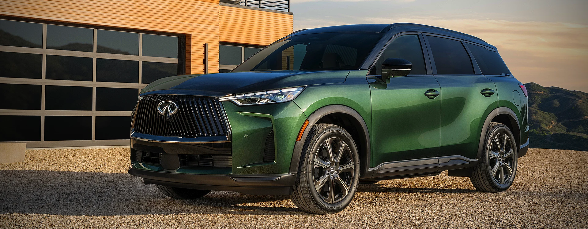 green INFINITI QX60 near building