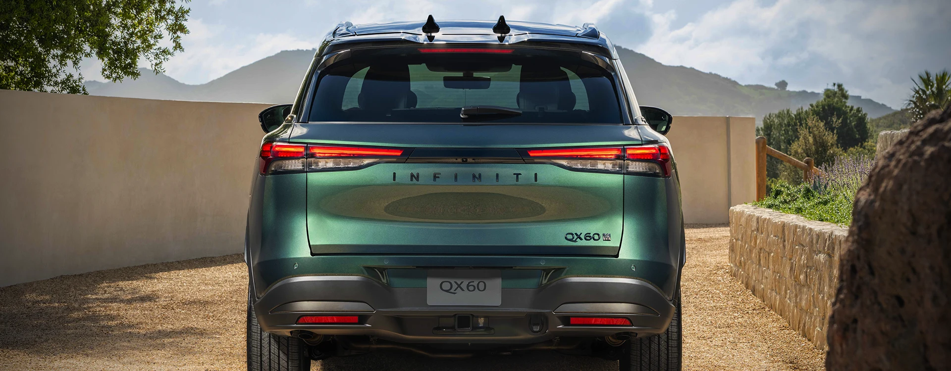 green INFINITI QX60 near building