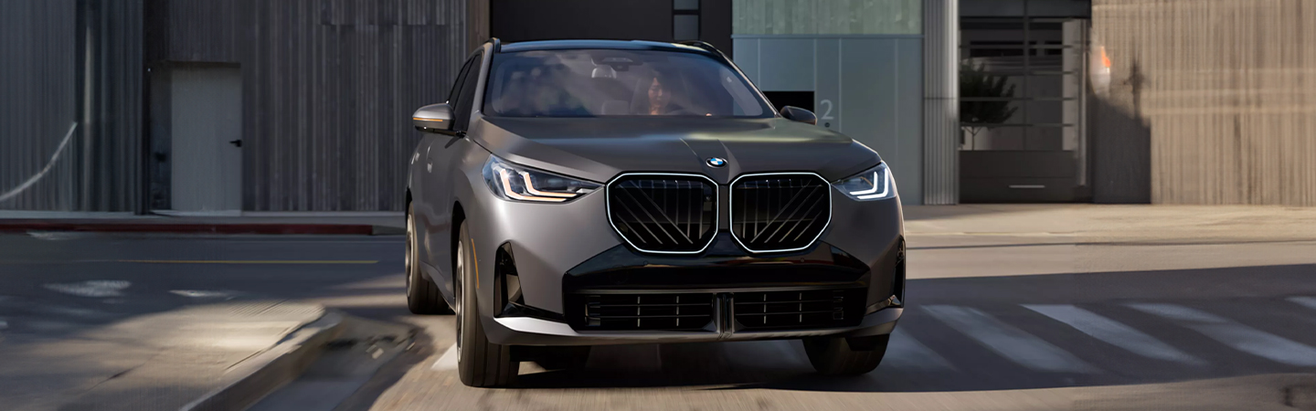 2025 BMW X3 driving on downtown streets