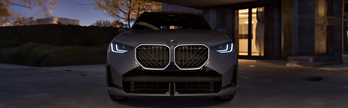 2025 BMW X3 parked at house at night