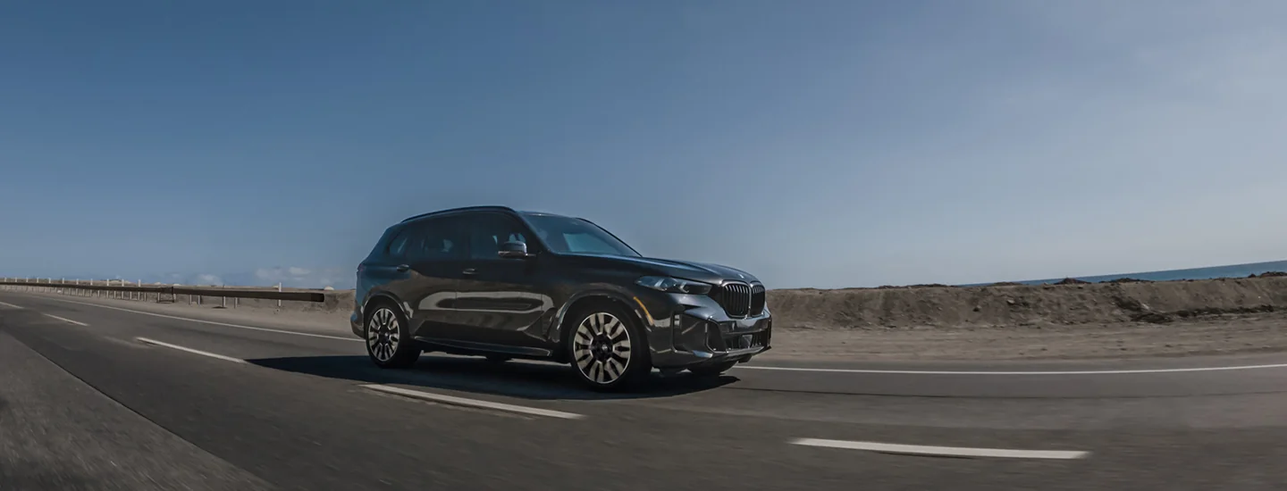2026 BMW X5 driving on a desert highway